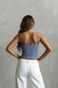 light blue tank top and white pants