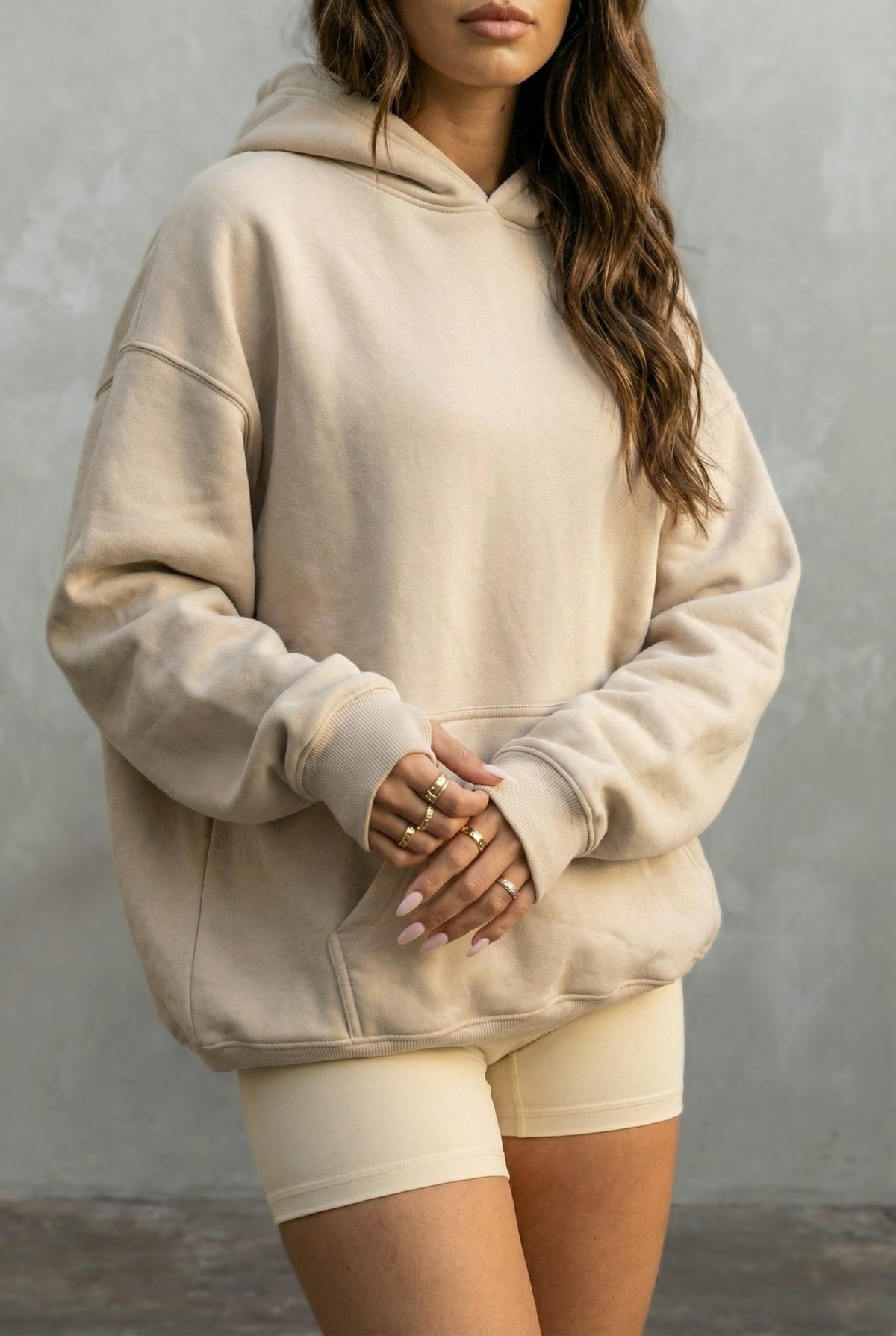 beige hoodie and shorts against a plain background