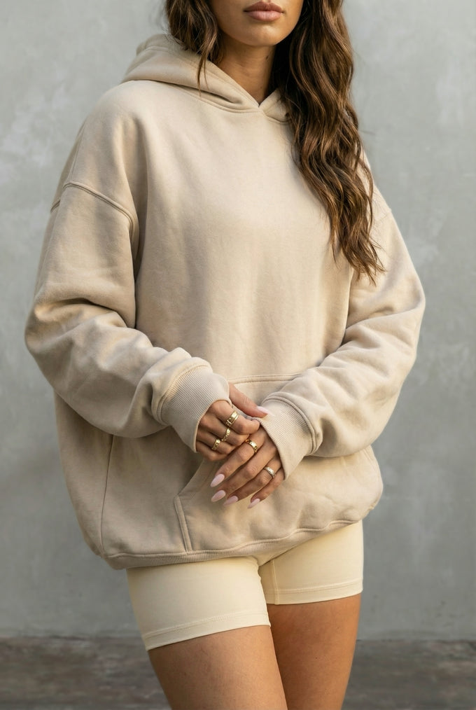 beige hoodie and shorts against a plain background